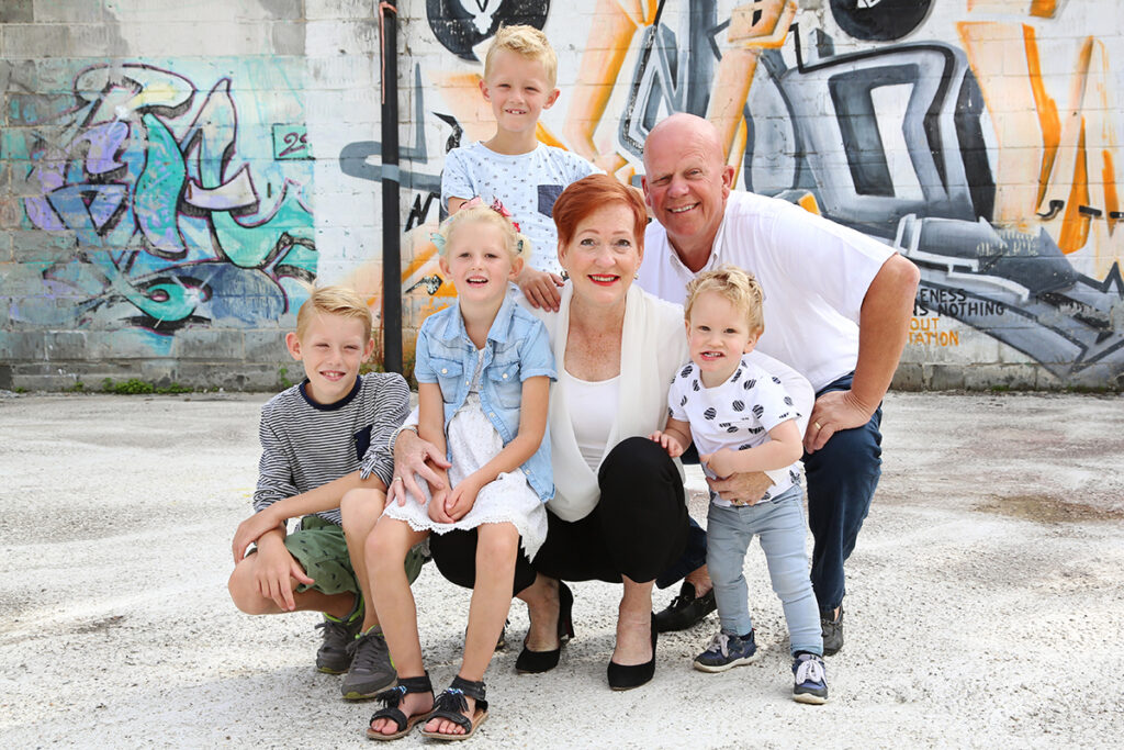 Opa, oma en kleinkinderen voor een graffitimuur, familiefoto