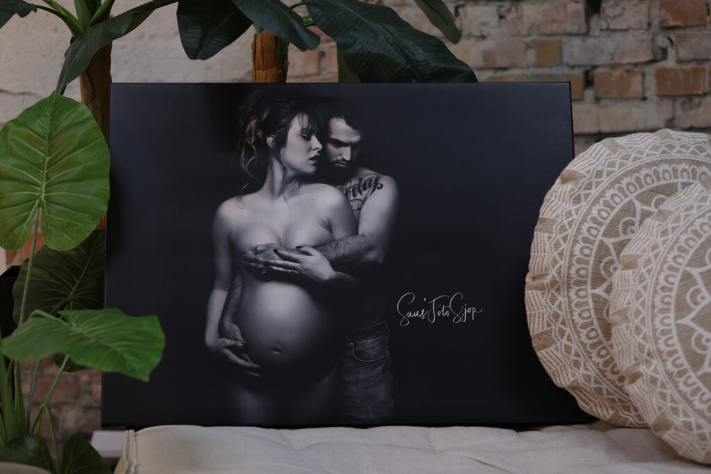 Zwart-wit zwangerschapsfoto op een plaat naast rieten decoratie