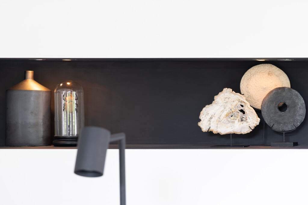 Zwarte wandnis met vazen en lamp, interieurdetail