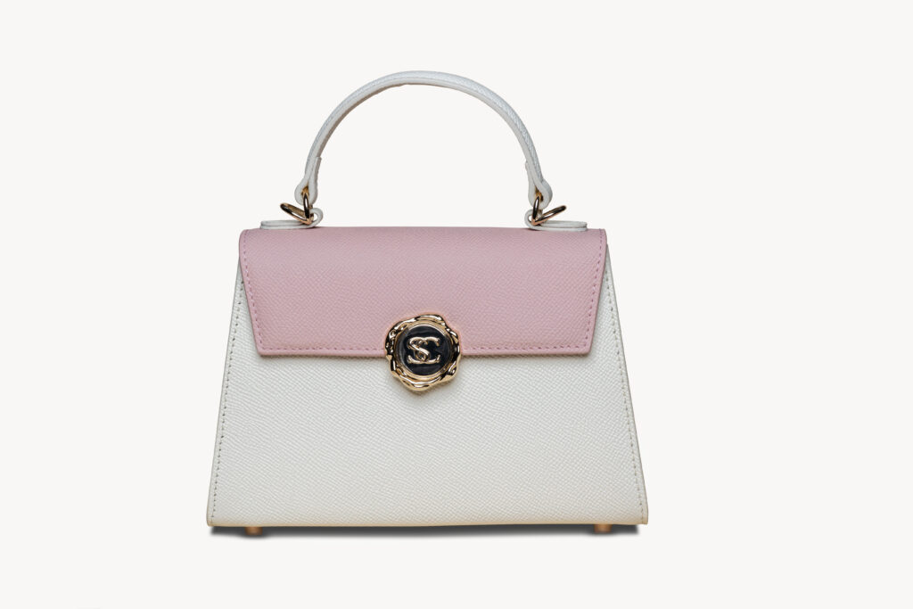 Roze-witte handtas met gouden sluiting, packshot