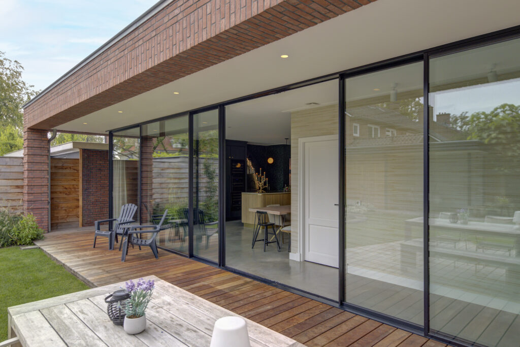 Moderne aanbouw met grote glazen pui en terras